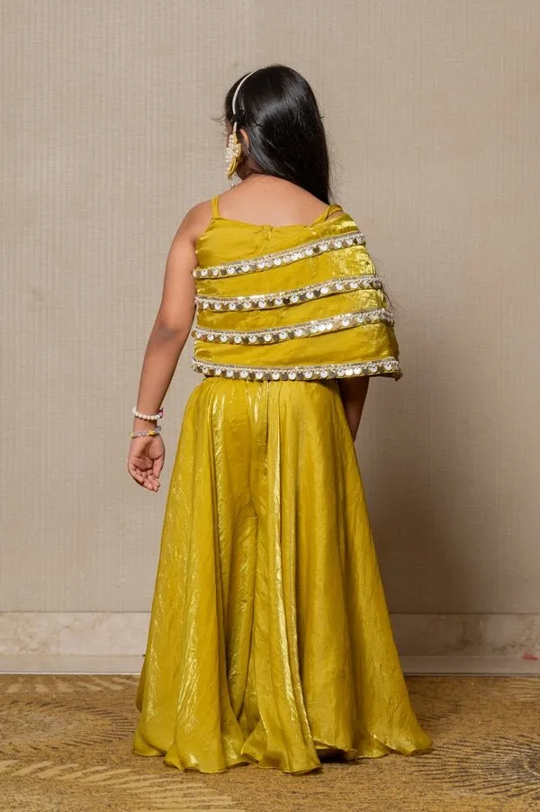 Vibrant golden-yellow ensemble with an asymmetrical top and wide-legged pants, perfect for making a bold statement at any festive occasion.